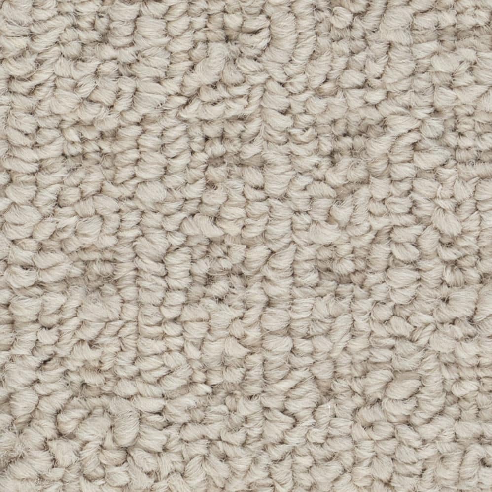 Close-up of beige loop pile carpet texture