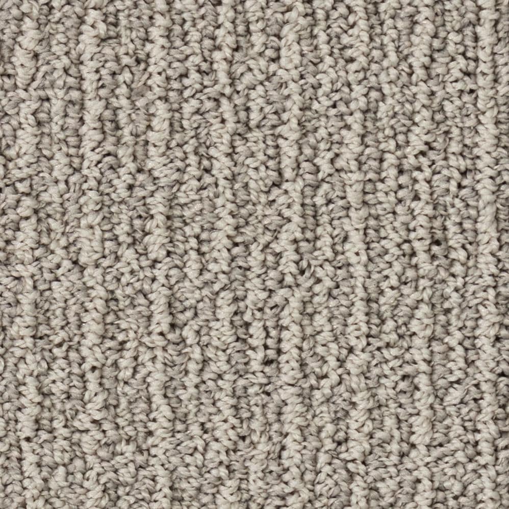 Close-up of beige textured carpet fibers