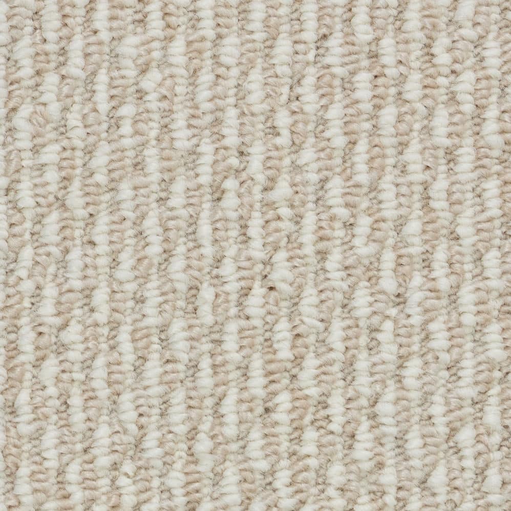 Close-up of beige textured carpet fibers