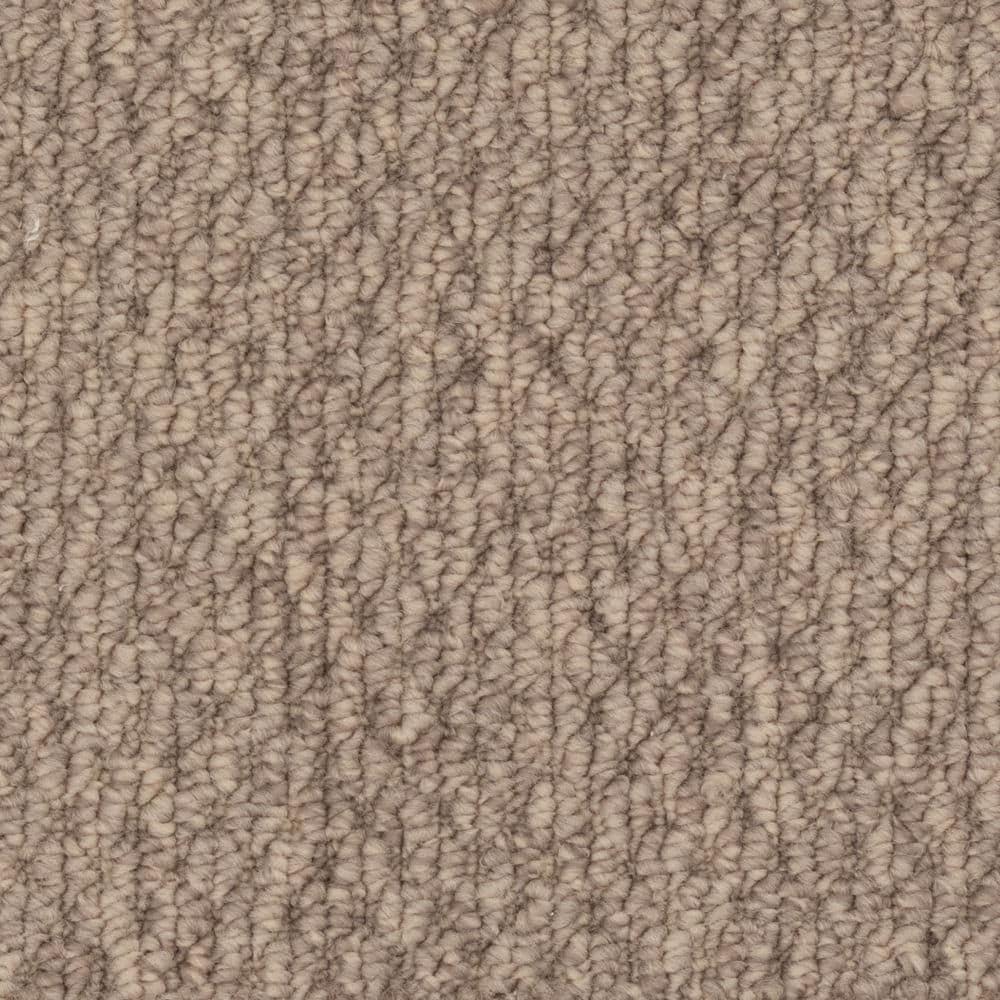 Close-up of beige textured carpet fibers