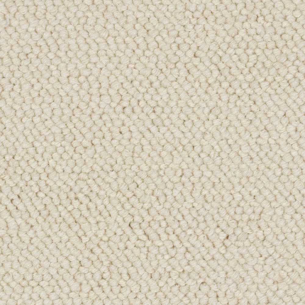 Close-up of cream textured carpet fibers