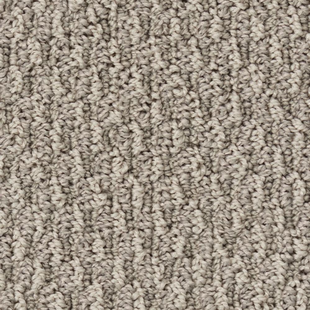 Close-up of beige textured carpet fibers