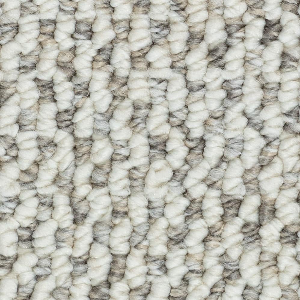Close-up of textured cream and gray carpet fibers