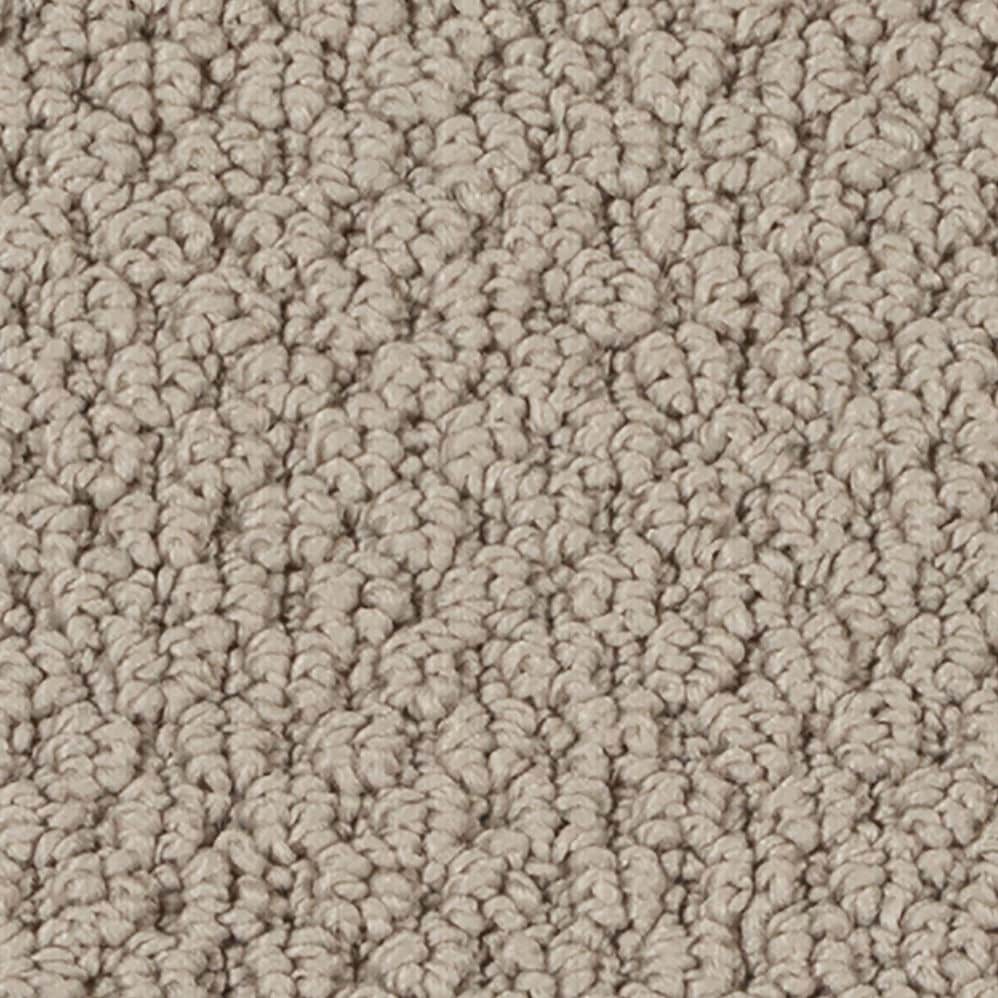 Close-up of beige textured carpet fibers