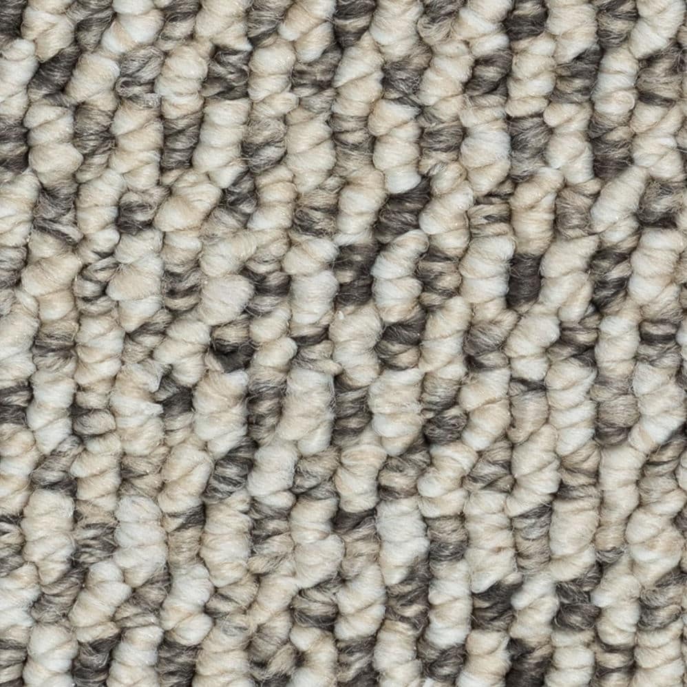 Close-up of beige and gray textured carpet fibers