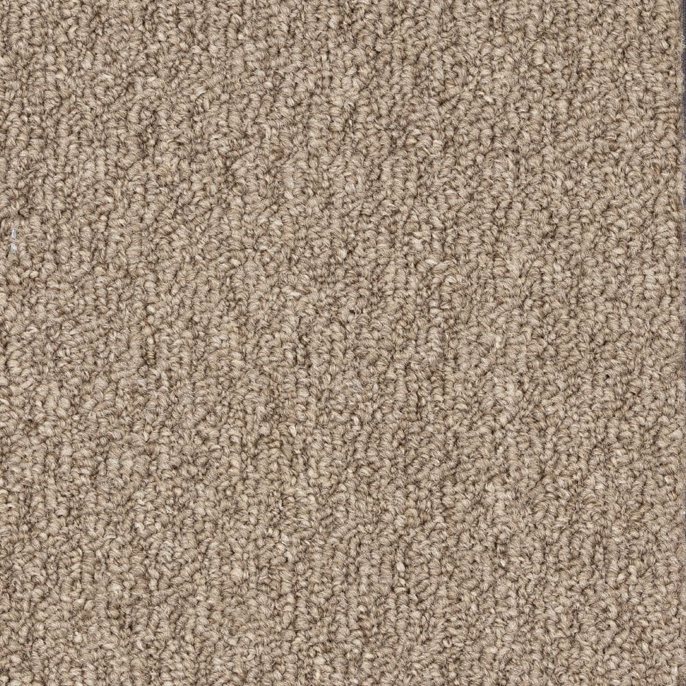 Close-up of beige textured carpet fibers