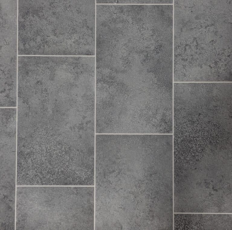 Gray textured rectangular wall tiles with white grout