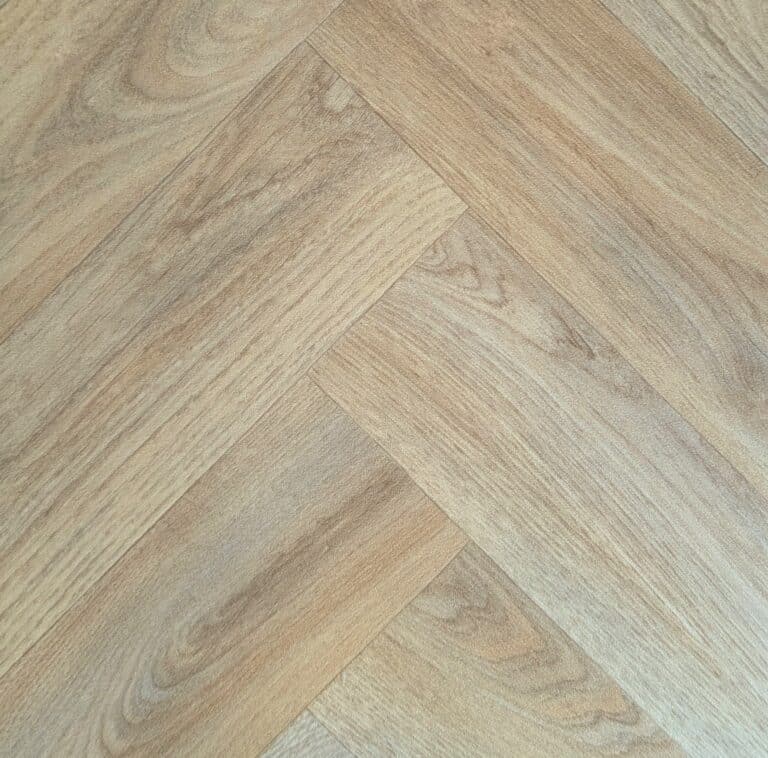 Light wood herringbone patterned flooring close-up